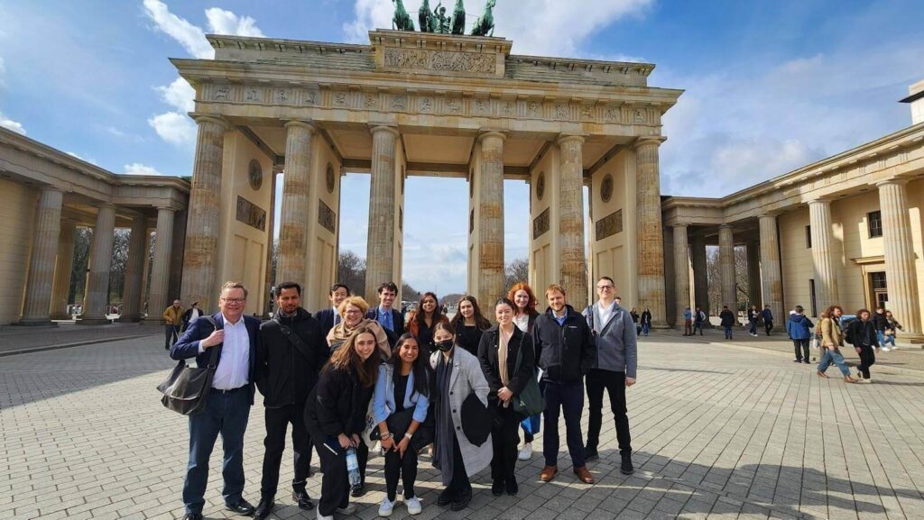 Students and trip leaders pose in front of the Brandenburg Gate before their visit to the US Embassy. Within days of this photo, this square hosted anti-Putin protests.