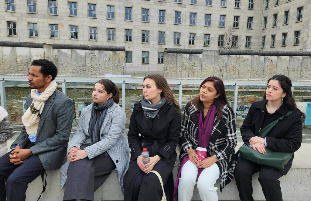 One unique experience of the trip was a tour through consequential sites in Berlin led by a guide originally from Syria, who drew parallels between important events in German history and key moments that led to the current situation in Syria. Here the group gathers near a still-standing section of the Berlin Wall.